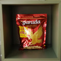 Red packet of Garuda roasted peanuts on a gray background